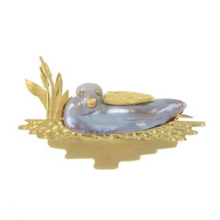 A cultured pearl novelty brooch. The baroque cultured pearl, decorated with textured wing, beak and