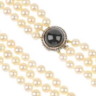 A cultured pearl three-row necklace, with garnet and rose-cut diamond clasp. The cultured pearls, me