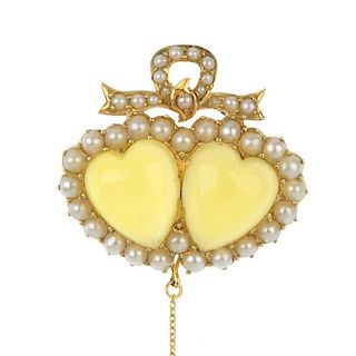 An early 20th century gold chrysoberyl and split pearl brooch. The replacement heart-shape chrysober