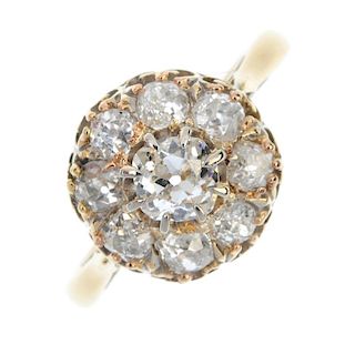 A mid 20th century 18ct gold diamond cluster ring. The old-cut diamond cluster, to the tapered shoul