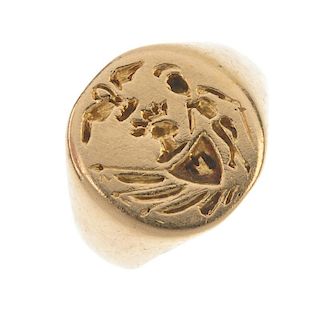A signet ring. The circular-shape panel, with  engraved crest, to the tapered shoulders. Ring size F