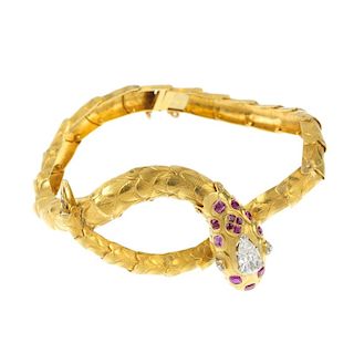<p>A diamond and ruby snake bracelet. The snake head set with a pear-shape diamond, with diamond poi