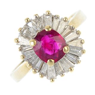 A ruby and diamond cluster ring.  The cushion-shape ruby, within a tapered baguette-cut diamond bord