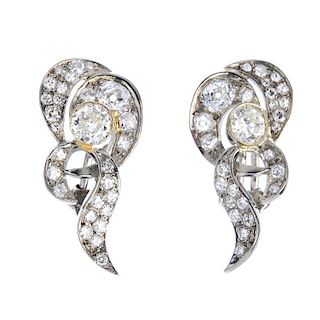 A pair of diamond earrings. Each designed as a circular-cut diamond collet, within an old and single