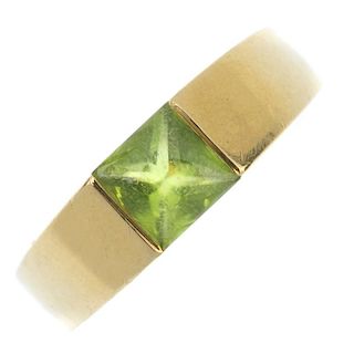 A peridot ring. The square-shape peridot cabochon, inset to the tapered band. Ring size N. Weight 9g
