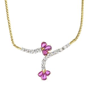 A 1980s 18ct gold ruby and diamond necklace. The front designed as a two pear-shape ruby trefoils, t