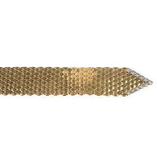 A diamond bracelet. Designed as a stylised belt, the fancy-link mesh panel, with brilliant-cut diamo