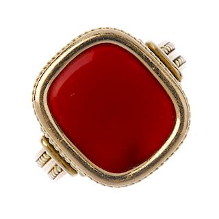 A gentleman's carnelian ring. The cushion-shape carnelian, to the rope-twist surround and scrolling