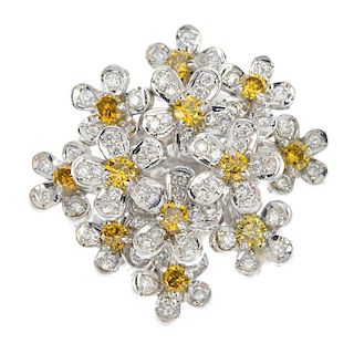 A diamond and colour treated diamond dress ring. Designed as a series of diamond and colour treated