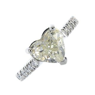 An 18ct gold diamond single-stone ring. The heart-shape diamond, to the brilliant-cut diamond line s