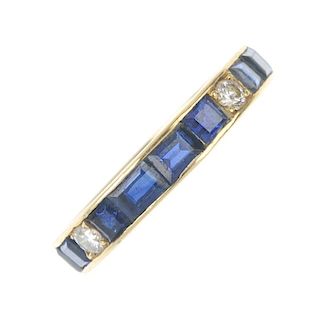 A sapphire and diamond full-circle eternity ring. Designed as a vari-shape sapphire line, with brill
