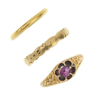 A selection of three rings. To include an oval-shape garnet single-stone ring with floral motif shou
