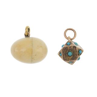 Two charms. The first designed as an early 20th century bone egg opening to reveal three bone miniat