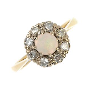 A mid 20th century 18ct gold opal and diamond cluster ring. The circular opal cabochon, within a sin