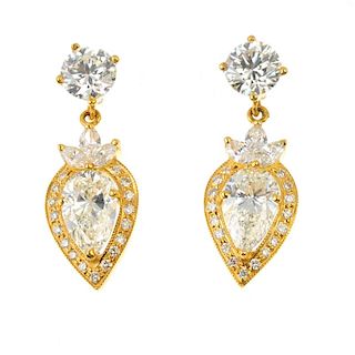 A pair of diamond ear pendants. Each designed as a pear and brilliant-cut diamond cluster drop, with