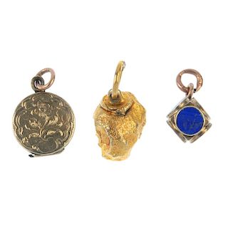 A collection of seven charms. To include an early 20th century gold enamel floral locket, an enamel