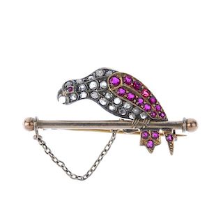 A late 19th century gold and silver, diamond and ruby bird brooch. Designed as a stylised parrot wit