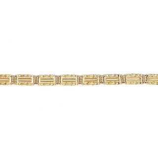 <p>An early 20th century 15ct gold gate bracelet. Designed as a series of gate links, with knot deta