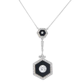 A diamond and onyx pendant. The circular-cut diamond collet, within a hexagonal-shape onyx and old-c