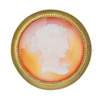 A late 19th century hardstone cameo brooch. The circular-shape agate cameo, depicting the profile of