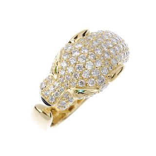 * A diamond and gem-set leopard ring. The pave-set diamond head, with circular-shape emerald eyes an