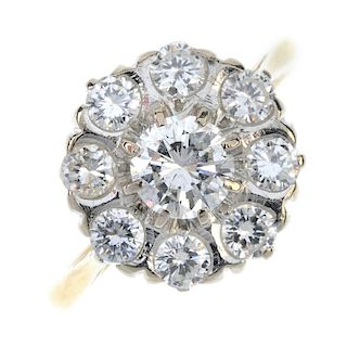 An 18ct gold diamond cluster ring. The brilliant-cut diamond, within a similarly-cut diamond surroun