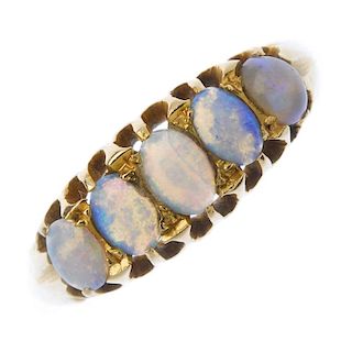 An early 20th century 18ct gold opal ring. The oval opal cabochon graduated line, to the openwork ga