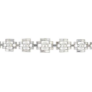 A cultured pearl and diamond bracelet. Of geometric design, the graduated cultured pearls, measuring