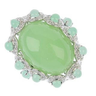 A chrysoprase and diamond dress ring. The oval chrysoprase cabochon, within a pear-shape chrysoprase