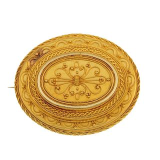 A late 19th century gold brooch. Of oval outline, the scrolling cannetille panel, within a stepped s