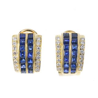 A pair of sapphire and diamond earrings. Each designed as two calibre-cut sapphire lines, with bar s