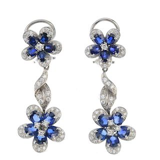 A pair of sapphire and diamond floral ear pendants. Each designed as an oval-shape sapphire and bril
