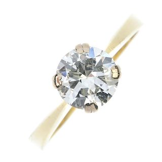 An 18ct gold diamond single-stone ring. The circular-cut diamond, to the tapered shoulders and plain