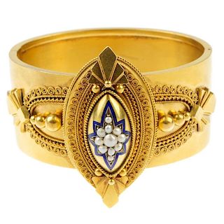 A mid Victorian gold enamel and split pearl bangle, circa 1870. The front designed as a split pearl