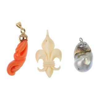 A selection of three pendants. To include a baroque cultured pearl pendant, an ivory fleur-de-lys pe