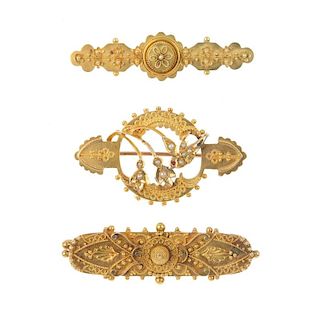 Three late 19th century gold brooches. To include a seed pearl and red gem openwork floral brooch wi