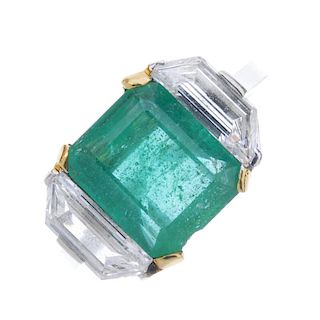An emerald and diamond three-stone ring. The rectangular-shape emerald, with trapezium-shape diamond