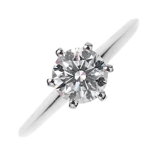 A platinum diamond single-stone ring. The brilliant-cut diamond, weighting 0.93ct, to the bevelled b
