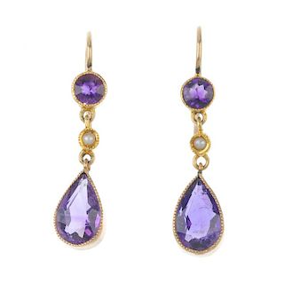 A pair of amethyst and split pearl ear pendants. Each designed as a pear-shape amethyst, suspended f