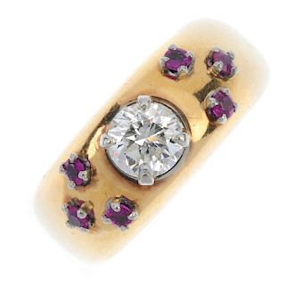 A diamond and ruby dress ring. The brilliant-cut diamond, to the circular-shape ruby trefoil sides.