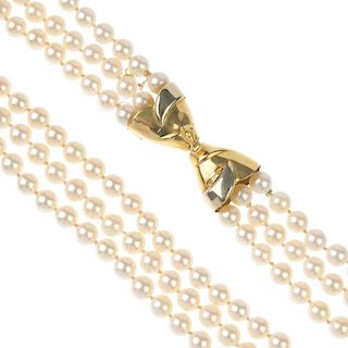 A cultured pearl three-row necklace. The cultured pearls, measuring 6mms, to the bi-colour push-piec