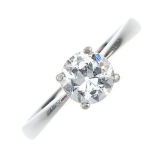 A platinum diamond single-stone ring. The circular-cut diamond, to the tapered shoulders and plain b