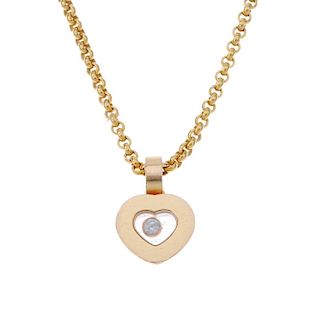 CHOPARD - an 18ct gold 'Happy Diamonds' pendant. The free-moving brilliant-cut diamond collet, withi