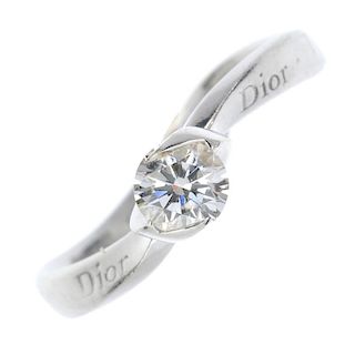 DIOR - a diamond single-stone ring. The brilliant-cut diamond, to the crossover setting and undulati