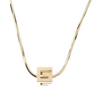 GUCCI - a set of jewellery. The pendant designed as a cube, with pierced G detail, suspended from a