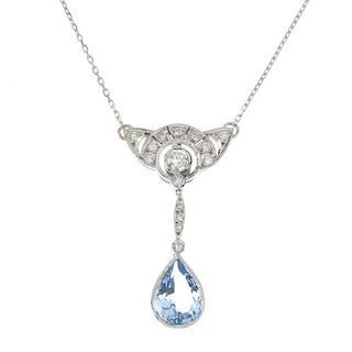 An aquamarine and diamond pendant. The pear-shape aquamarine collet, suspended from a brilliant-cut
