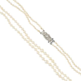 A cultured pearl two-row necklace. Comprising two rows of graduated cultured pearls, to the textured