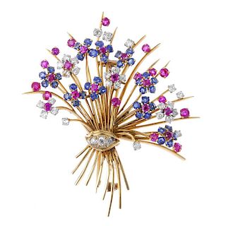 A mid 20th century diamond, sapphire and ruby floral spray brooch.The circular-shape sapphire, ruby