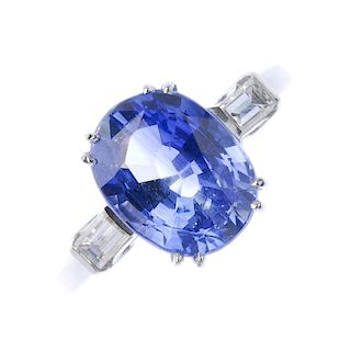 A sapphire and diamond three-stone ring. The oval-shape sapphire, to the baguette-cut diamond should
