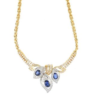 A sapphire and diamond necklace. Designed as an oval-shape sapphire and brilliant-cut diamond foliat